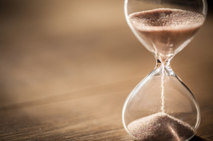 Sand falls through an hourglass.