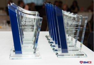 Glass statuettes recognizing BMC2 PCI Excellence in Cardiovascular Quality are lined up on a table.