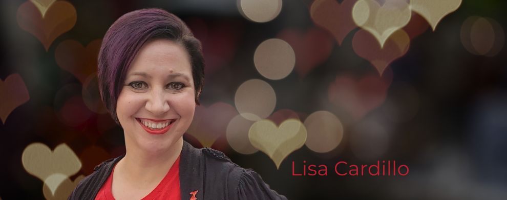 Lisa Cardillo has short, dark hair and wears a red shirt under a black cardigan.