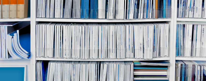 A white book case is full of medical journals.